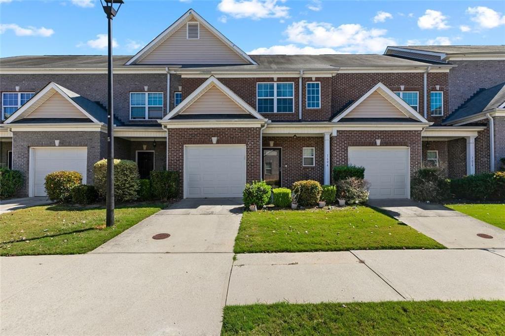 2555 Flat Shoals Road, Unit 5 Atlanta, GA 30349 - Photo 2 of 24 a front view of a house with a yard