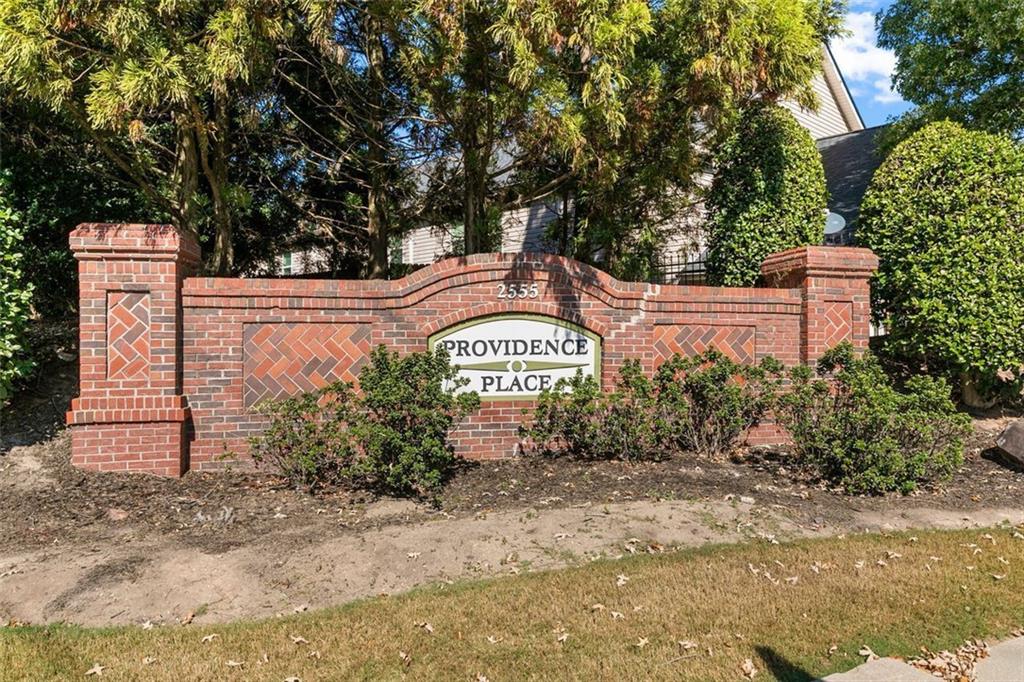 2555 Flat Shoals Road, Unit 5 Atlanta, GA 30349 - Photo 24 of 24 a front view of a house with a garden