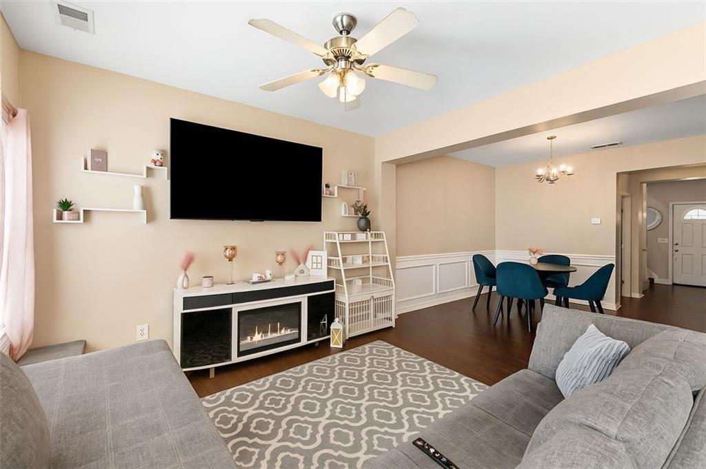 2555 Flat Shoals Road, Unit 5 Atlanta, GA 30349 - Photo 3 of 24 a living room with furniture and a flat screen tv