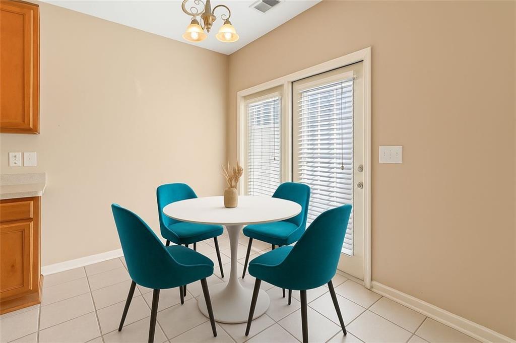 2555 Flat Shoals Road, Unit 5 Atlanta, GA 30349 - Photo 5 of 24 a view of a dining room with furniture and wooden floor
