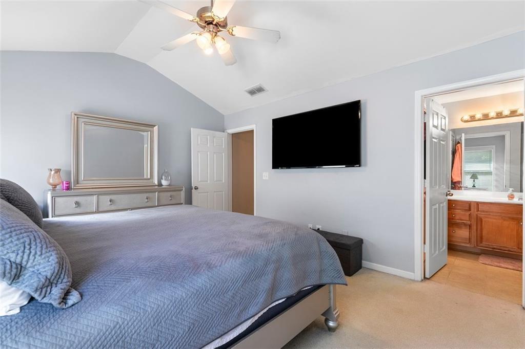 2555 Flat Shoals Road, Unit 5 Atlanta, GA 30349 - Photo 9 of 24 a bedroom with a bed a television and a large window