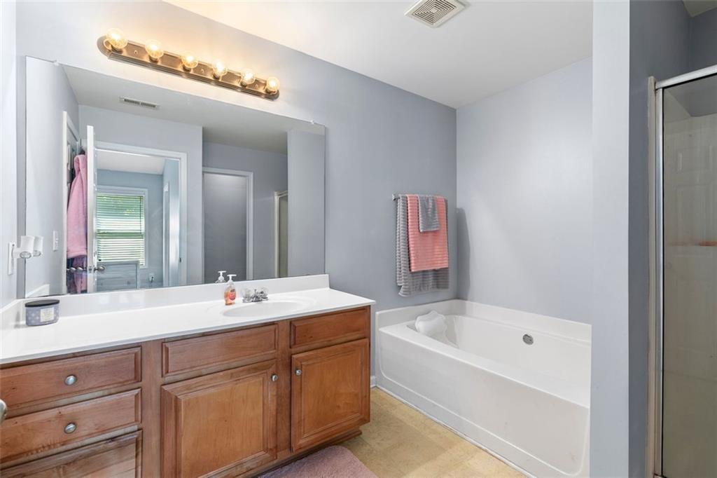 2555 Flat Shoals Road, Unit 5 Atlanta, GA 30349 - Photo 10 of 24 a bathroom with a bathtub sink and mirror