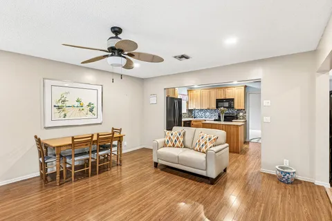 a living room with furniture and a wooden floor
