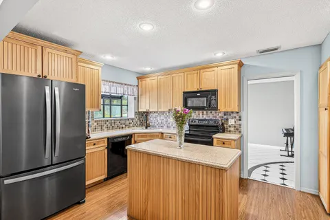 a kitchen with refrigerator a stove a sink and a microwave