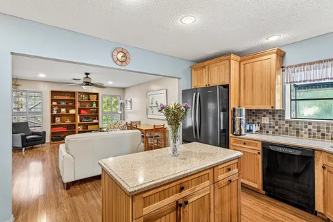 a kitchen with a stove a refrigerator and a stove top oven