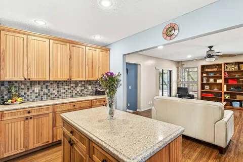 a kitchen with stainless steel appliances granite countertop a sink and cabinets