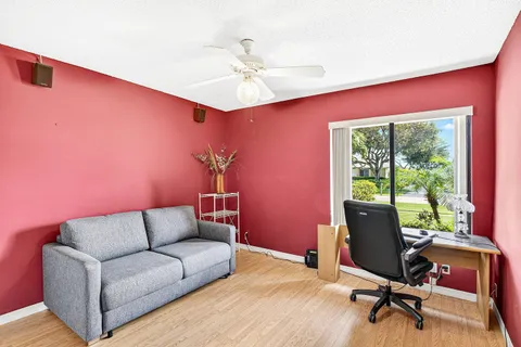 a living room with furniture floor to ceiling window