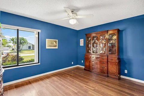 a view of empty room with window and ceiling fan