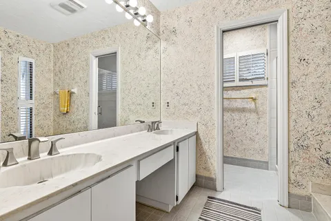 a bathroom with a sink double vanity and a shower