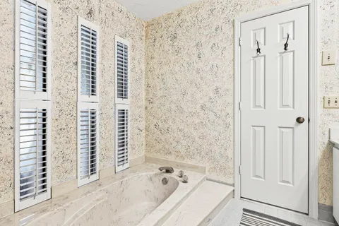 a bathroom with a bathtub and shower
