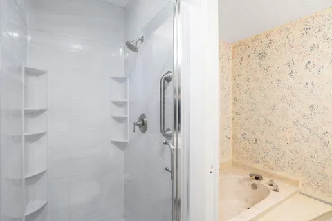 a bathroom with a bathtub and shower