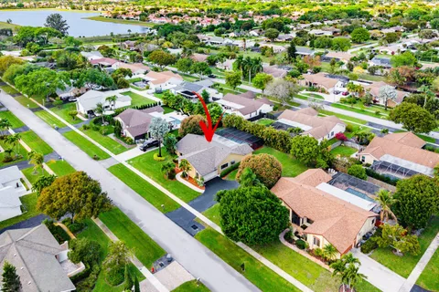 an aerial view of residential houses with outdoor space and lake view