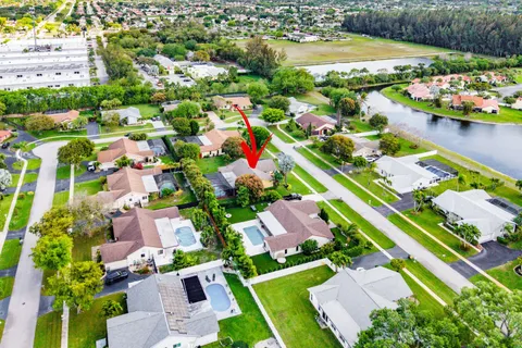 an aerial view of multiple houses with a yard