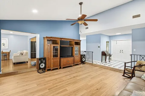 a view of a livingroom with furniture and a ceiling fan
