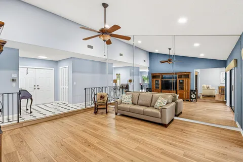 a living room with furniture and a wooden floor
