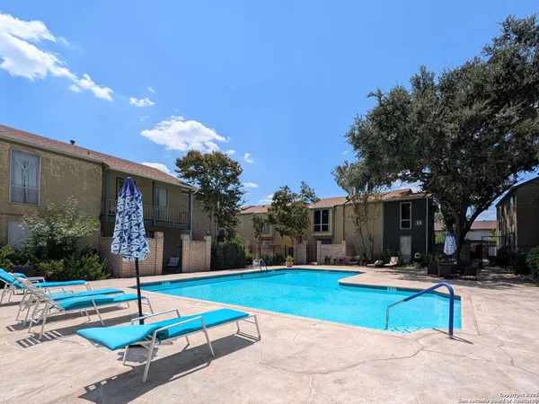 a view of a house with swimming pool and a yard