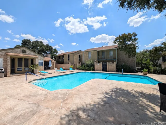 an aerial view of residential houses with outdoor space and ocean view