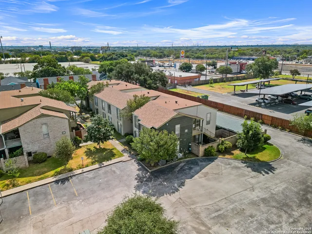 an aerial view of residential houses with outdoor space