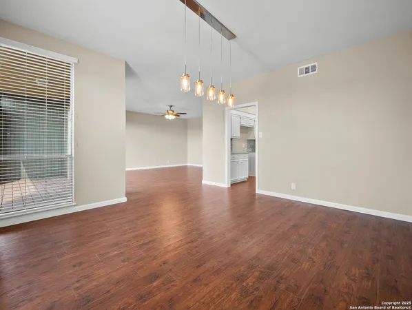wooden floor in an empty room with a window