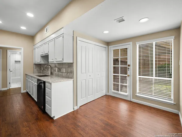 a kitchen with stainless steel appliances granite countertop a stove a sink and a microwave