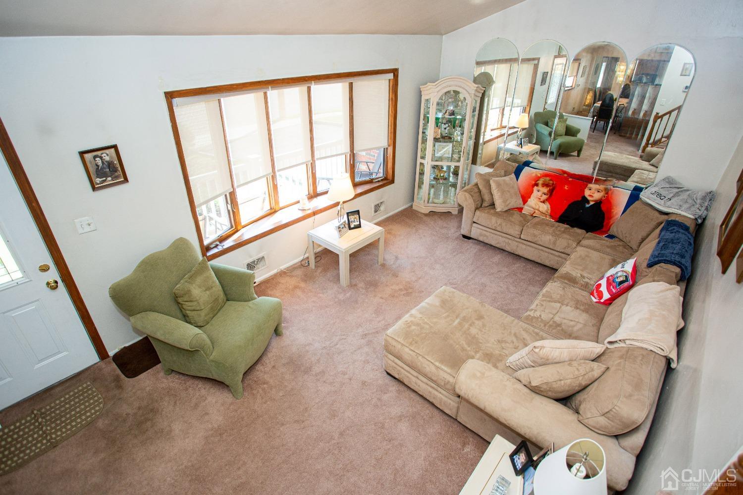 18 Westminster Road Colonia, NJ 07067 - Photo 7 of 36 a living room with furniture and a large window