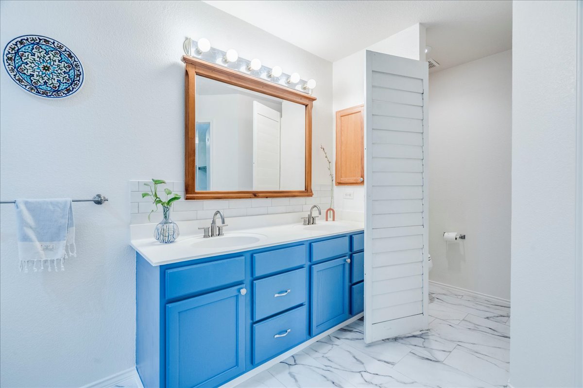 200 South Prairie Lane Georgetown, TX 78633 - Photo 16 of 28 a bathroom with a double vanity sink and a mirror