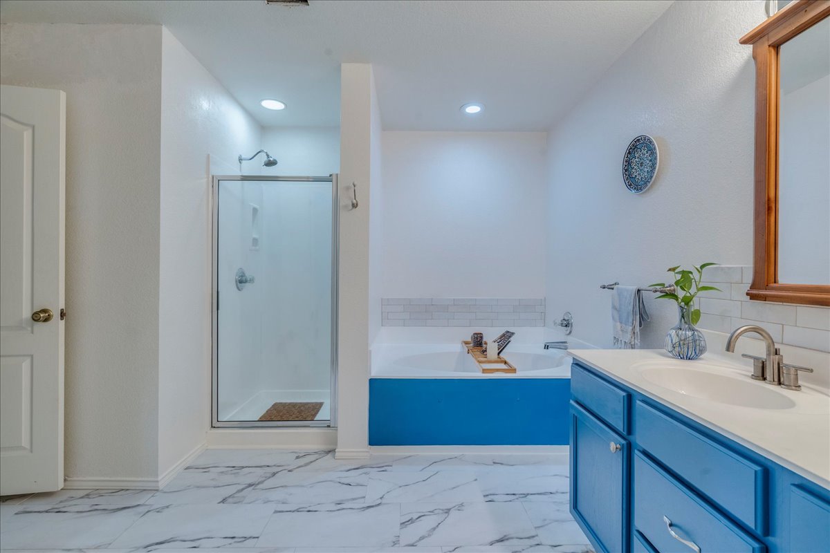 200 South Prairie Lane Georgetown, TX 78633 - Photo 17 of 28 a bathroom with a tub sink and mirror