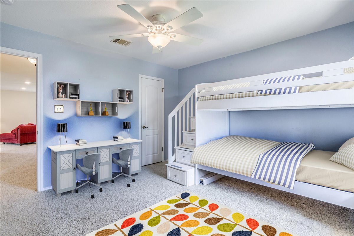 200 South Prairie Lane Georgetown, TX 78633 - Photo 21 of 28 a bedroom with a bed and a chandelier