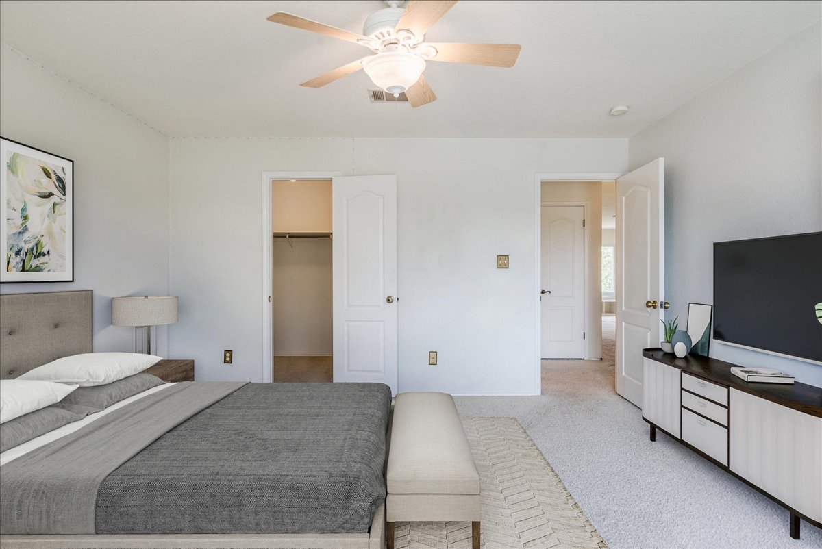 200 South Prairie Lane Georgetown, TX 78633 - Photo 23 of 28 a bedroom with a bed and a flat screen tv