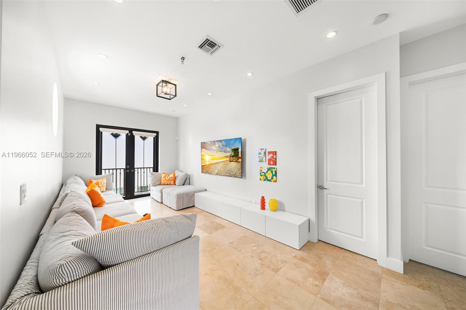 6001 Southwest 28th Street Miami, FL 33155 - Photo 17 of 30 a living room with furniture and a flat screen tv