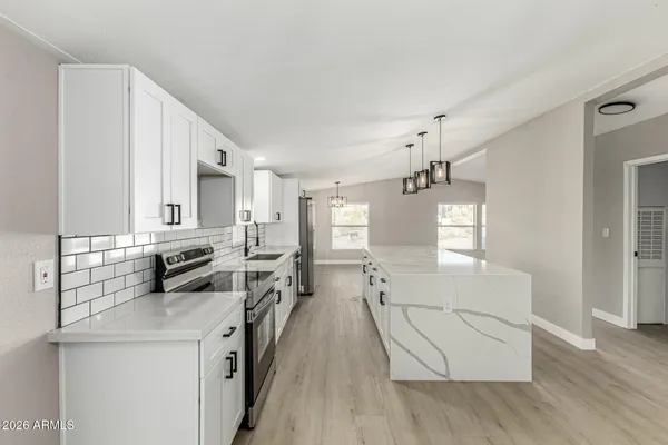 a view of a kitchen with sink and wooden floor