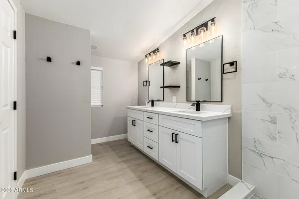a bathroom with a double vanity sink mirror and