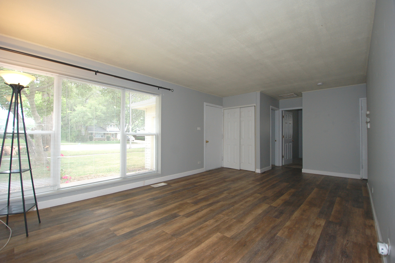 2713 Wilke Road Rolling Meadows, IL 60008 - Photo 3 of 14 a view of an empty room with wooden floor and a window
