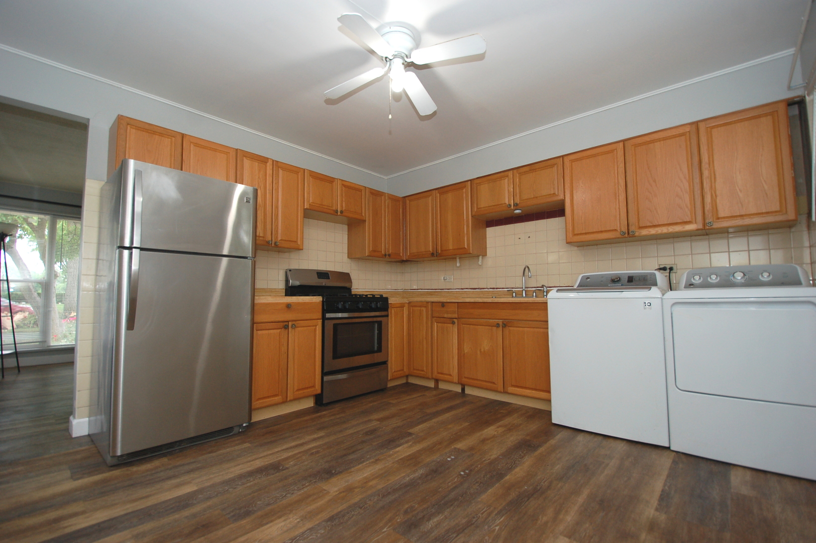 2713 Wilke Road Rolling Meadows, IL 60008 - Photo 6 of 14 a kitchen with a refrigerator sink and cabinets
