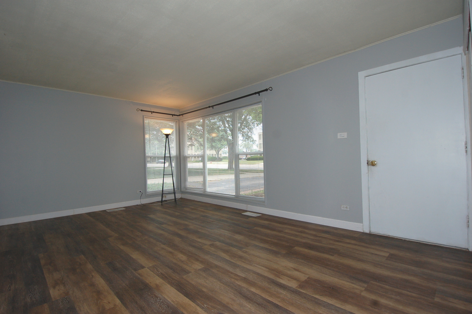 2713 Wilke Road Rolling Meadows, IL 60008 - Photo 8 of 14 a view of an empty room with wooden floor and a window