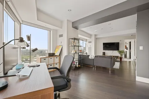 a bedroom with a bed and a large window