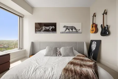 a bedroom with a bed and wall painting