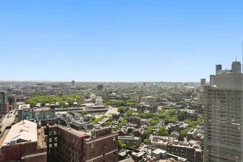 a view of hallway with wooden floor