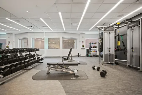 a room with gym equipment and large window