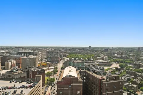 a dining room with furniture a flat screen tv and a large window