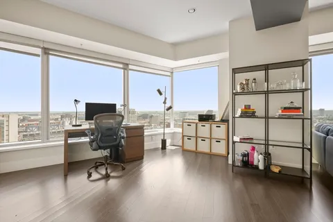 a view of a workspace with furniture and a window