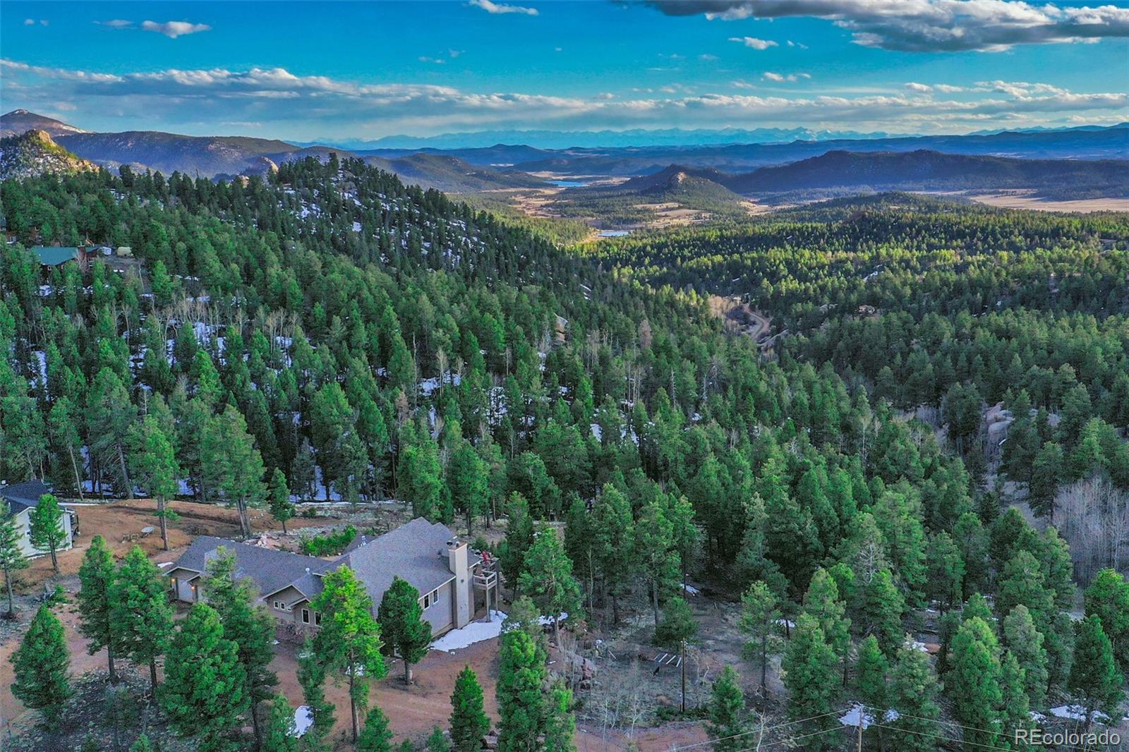 290 North Mountain Estates Road Florissant, CO 80816 - Photo 8 of 12 a view of a city with lush green forest