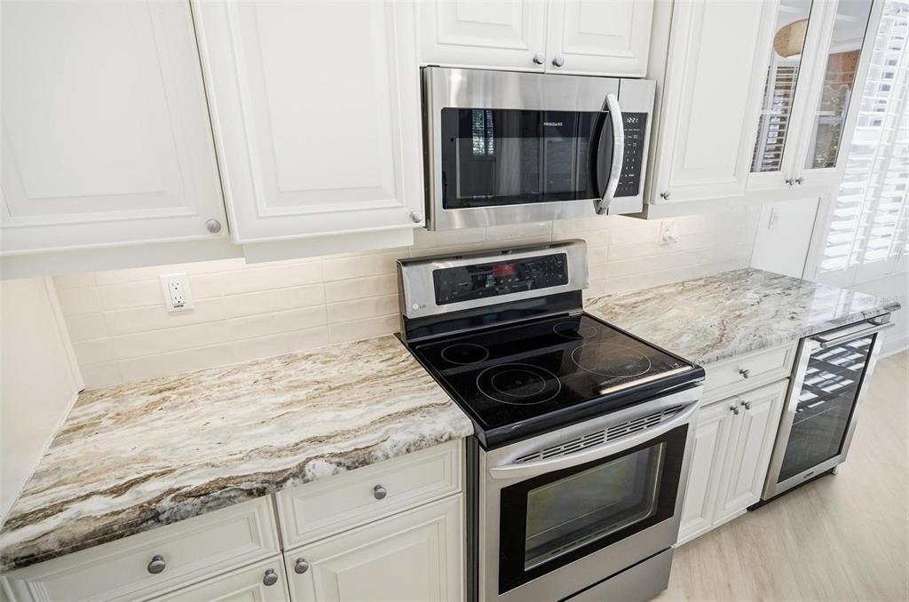 16 Village View Way Palm Coast, FL 32137 - Photo 11 of 89 a kitchen with granite countertop a stove and a microwave