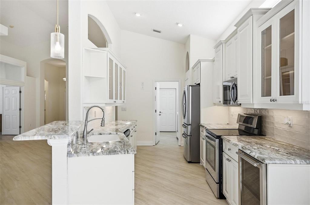 16 Village View Way Palm Coast, FL 32137 - Photo 13 of 89 a kitchen with a sink stove and refrigerator
