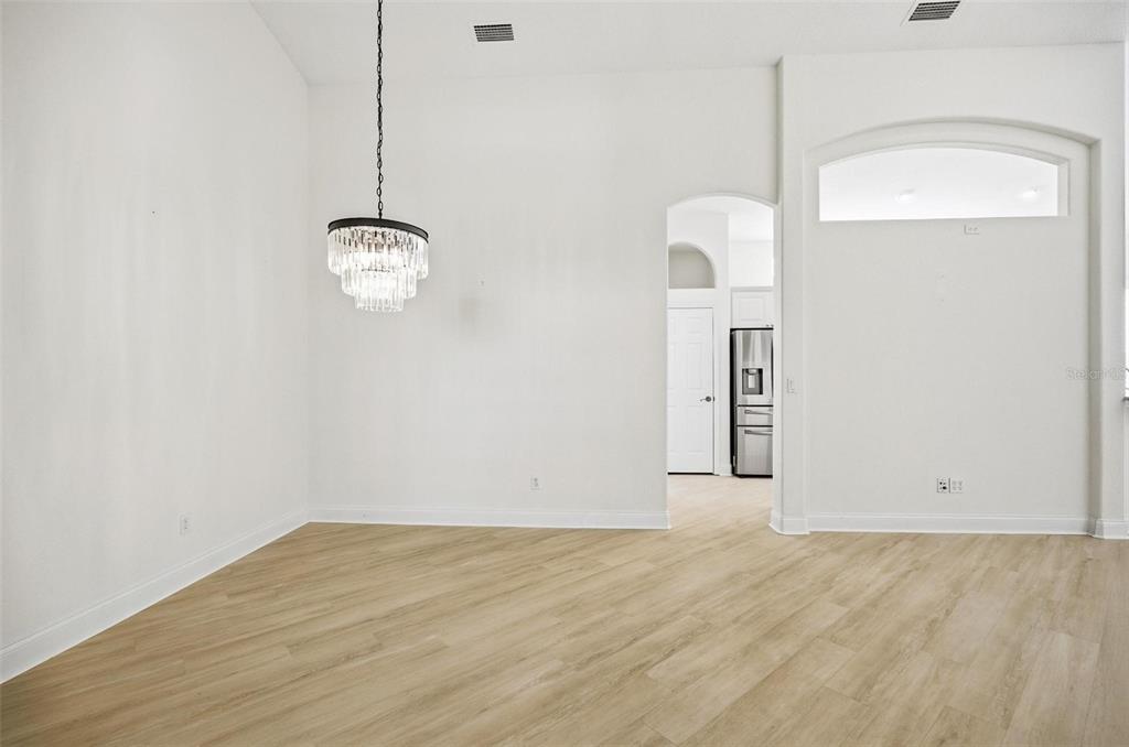 16 Village View Way Palm Coast, FL 32137 - Photo 26 of 89 an empty room with wooden floor and windows