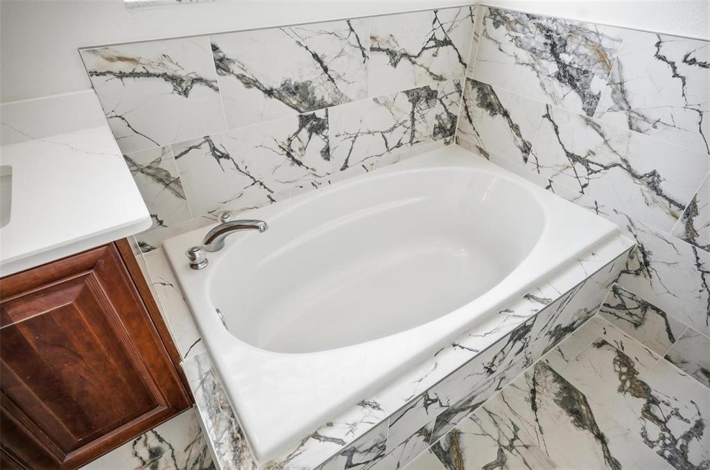 16 Village View Way Palm Coast, FL 32137 - Photo 38 of 89 a bathroom with a bathtub and shower