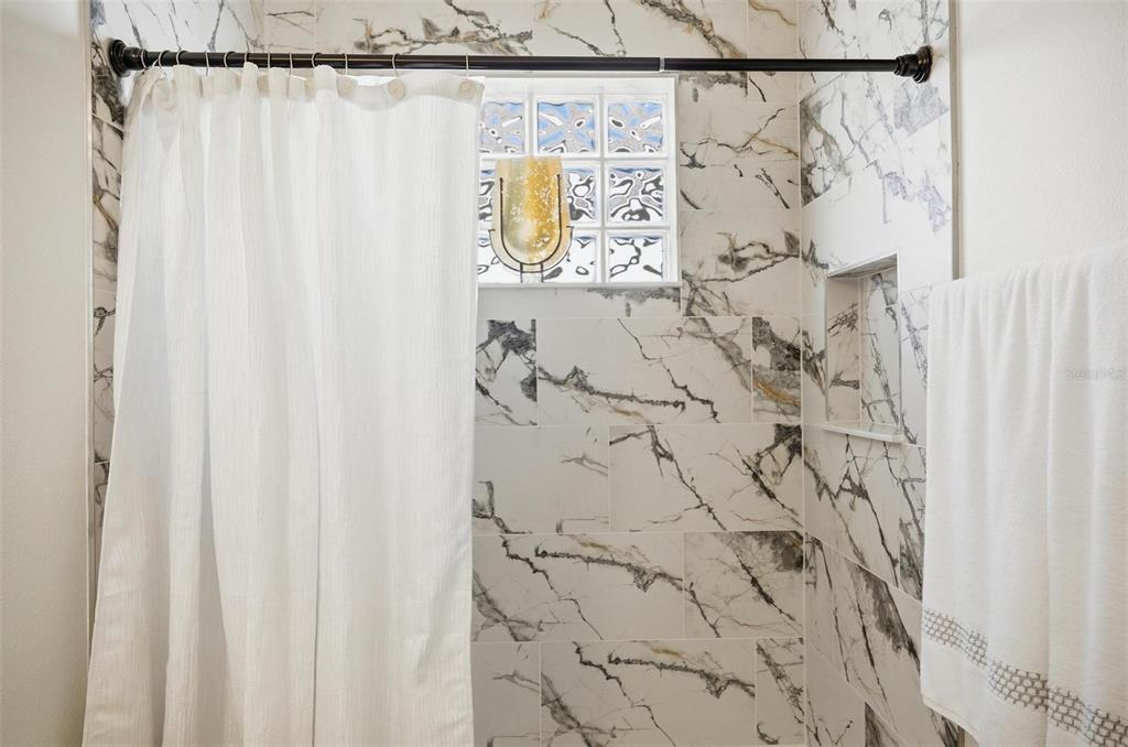 16 Village View Way Palm Coast, FL 32137 - Photo 44 of 89 a bathroom with a shower curtain and a shower curtain