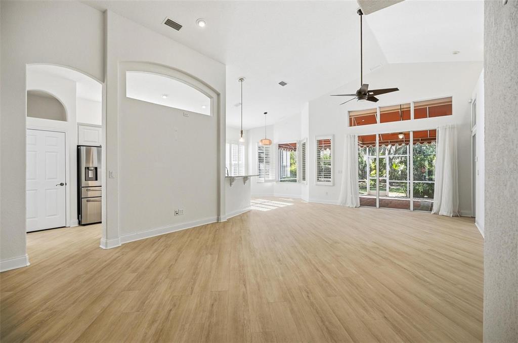 16 Village View Way Palm Coast, FL 32137 - Photo 9 of 89 a view of an empty room with wooden floor and a window