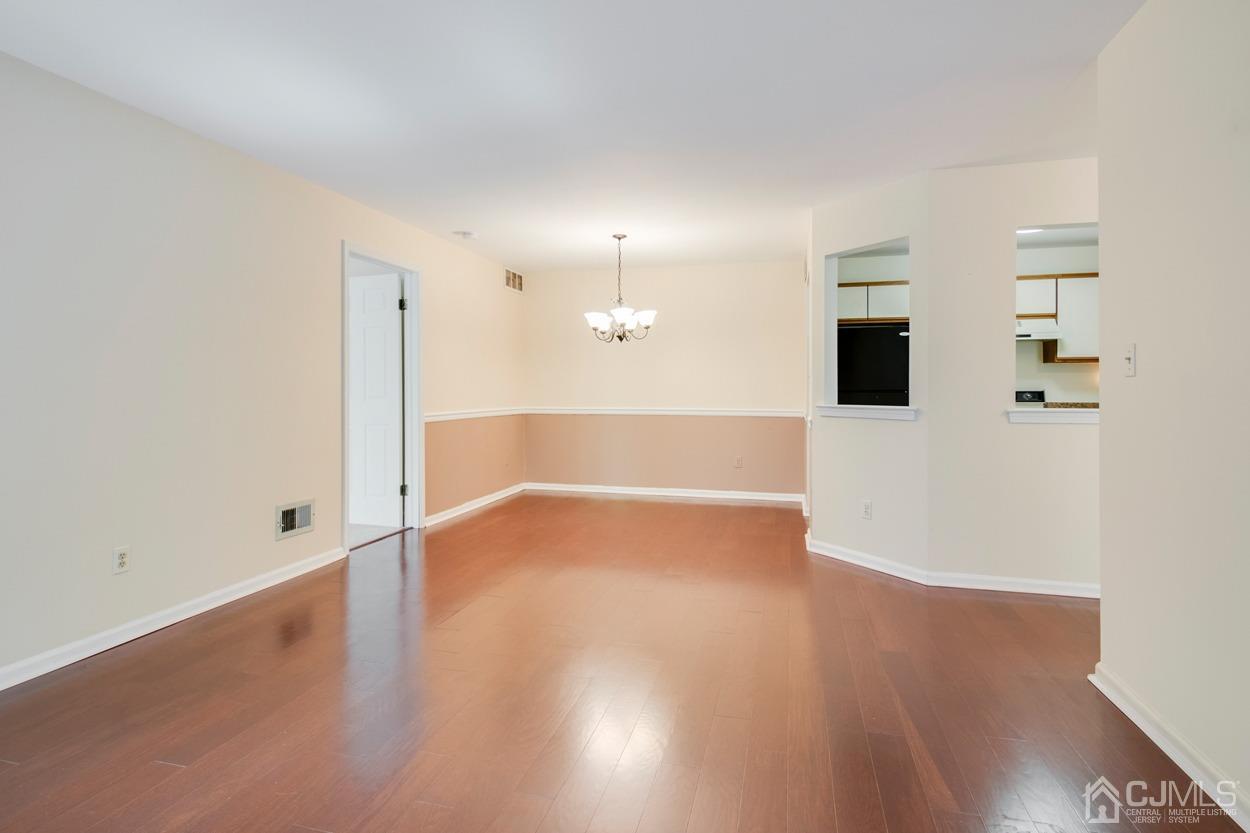 205 Raintree Court Helmetta, NJ 08828 - Photo 8 of 25 a view of an empty room with wooden floor
