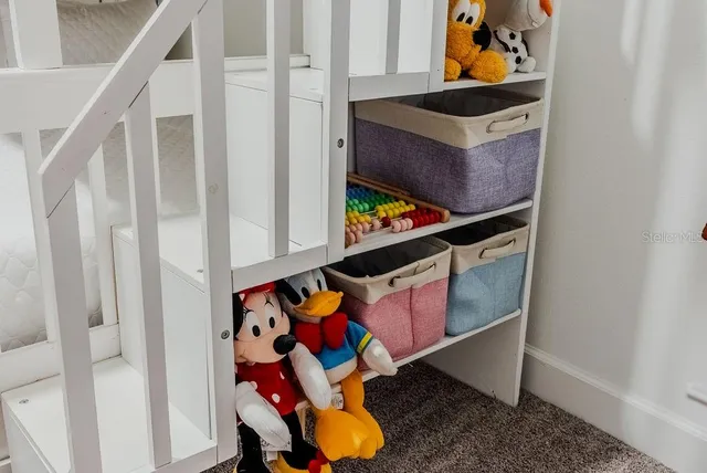 a bedroom with a large bed and a flat tv screen on dresser